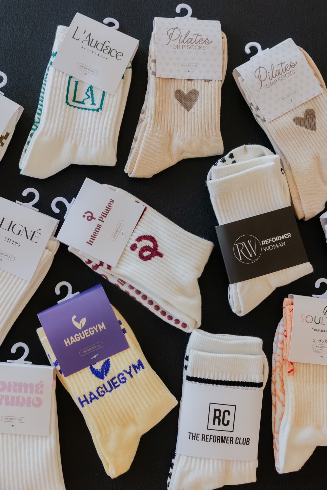 Custom grip socks with studio-branded packaging