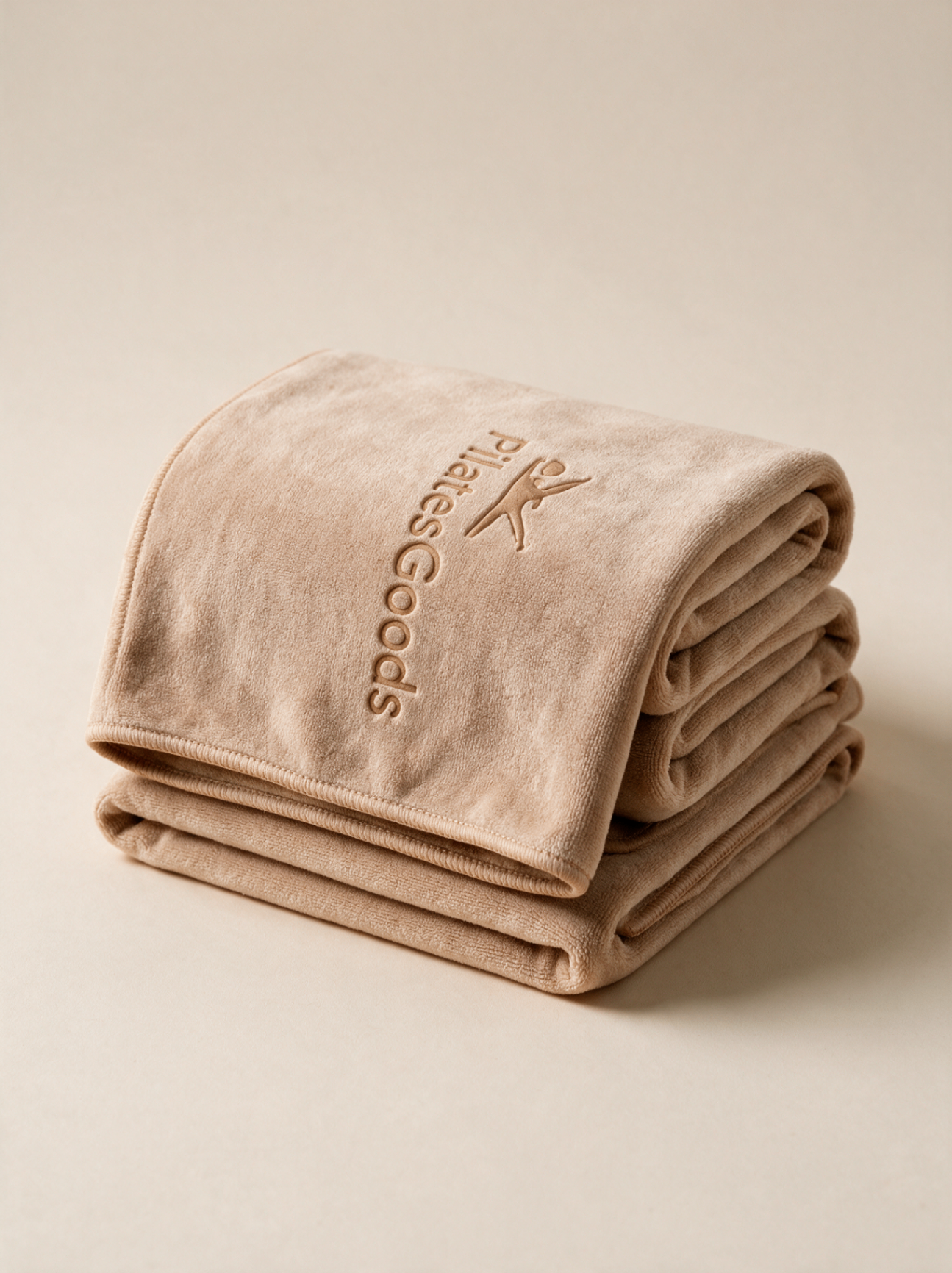 Custom branded Pilates microfiber towel in soft beige with embossed Pilates Goods logo, available in 20+ colors
