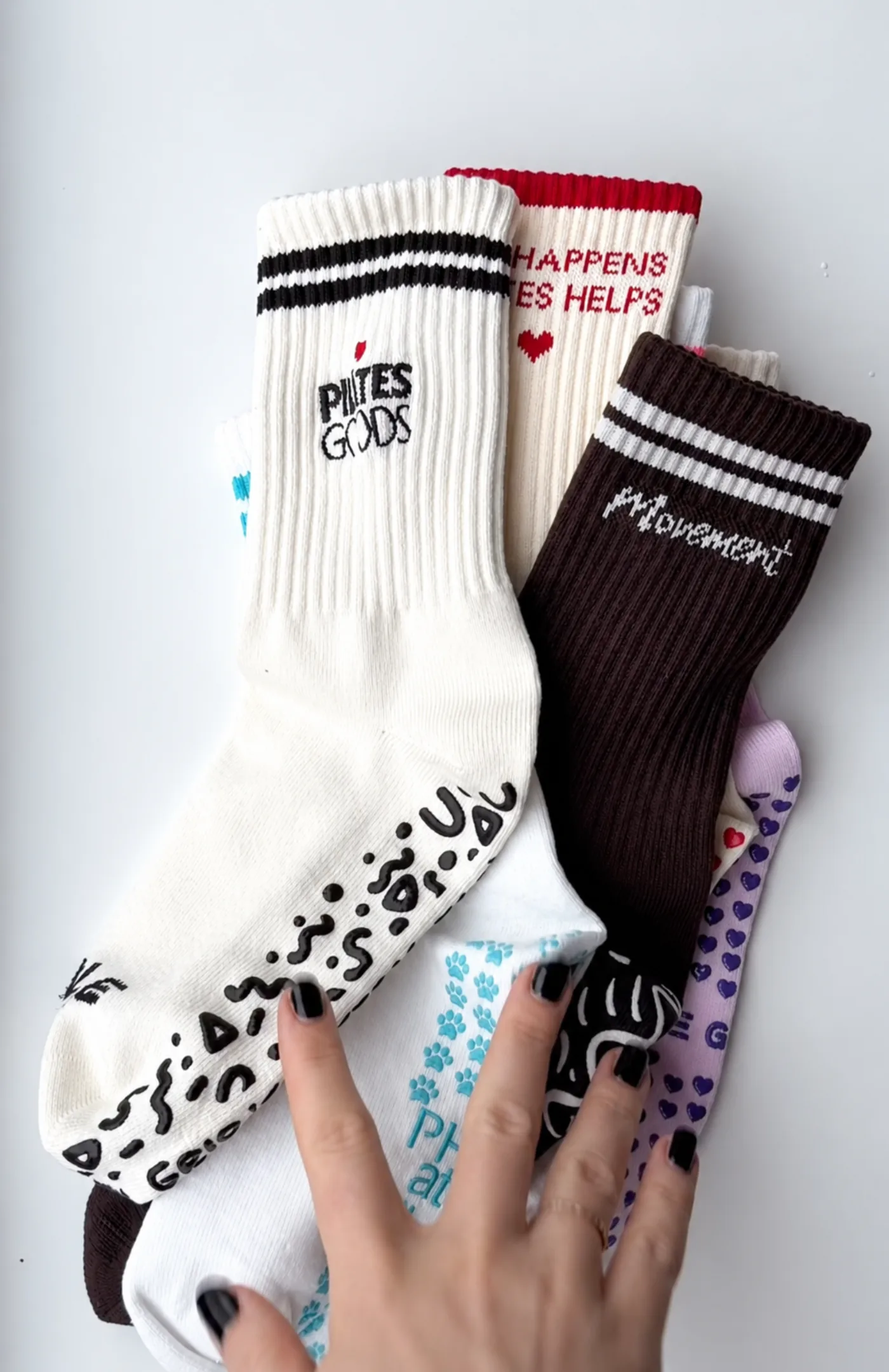 Custom branded studio merch collection including embroidered Pilates cap, grip socks and bag