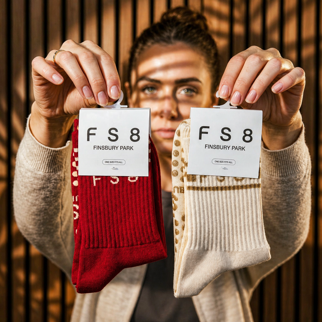 Branded custom Pilates studio socks in red and ivory with FS8 Finsbury Park studio logo packaging